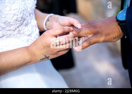 Braut`s Ring auf den Finger des Bräutigams Stockfoto